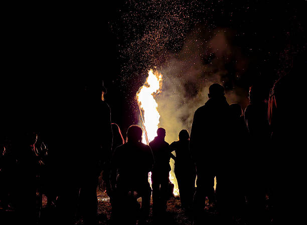 istock People gathered around a large bonfire at night 2234504626