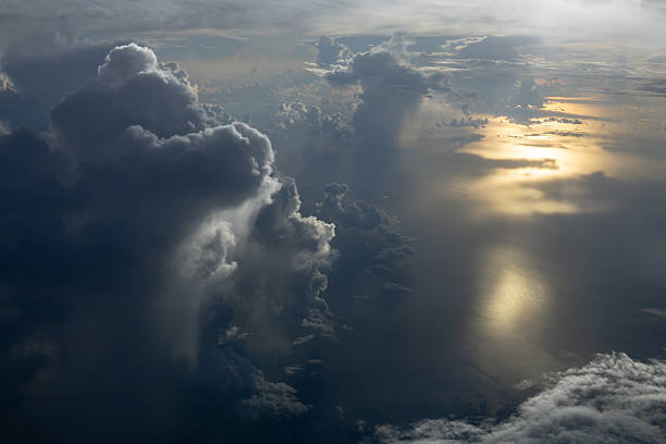 Aerial view of back lit thunderstorm clouds and sunlight reflecting in the Gulf of America (Mexico) on the Florida Gulf Coast