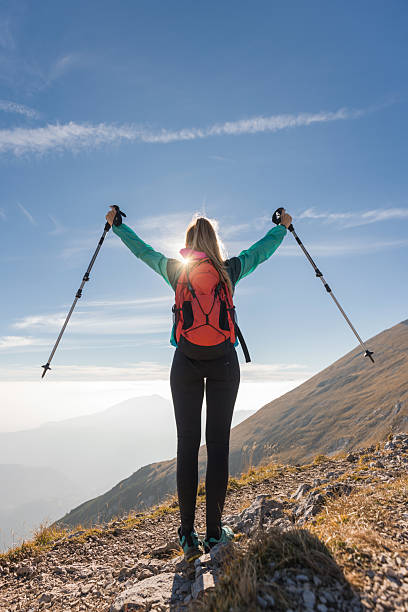 istock Woman on mountain at sunset 2234506618