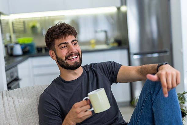 istock Young man enjoying morning coffee in his cozy home 2234508752
