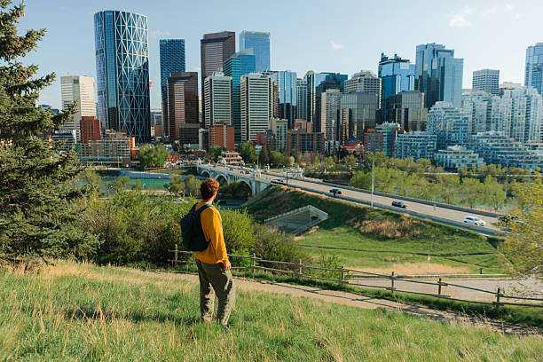 istock Man with backpack looking at Calgary cityscape in springtime 2234510768