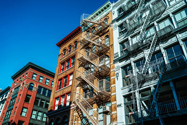 istock Historical Urban Buildings with Fire Escapes Under Clear Blue Sky 2234511013
