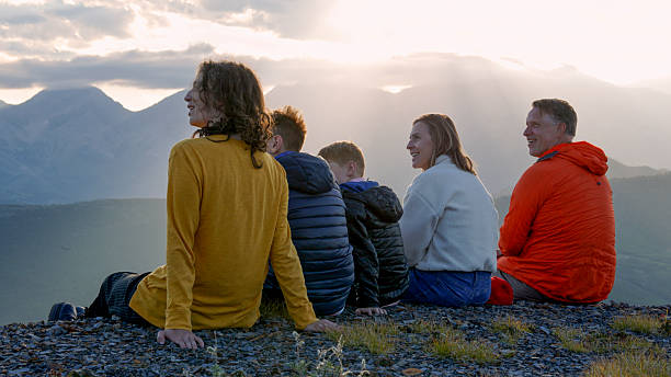 istock Family explores mountain ridge crest at sunset 2234511036