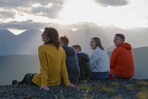 istock Family explores mountain ridge crest at sunset 2234511154