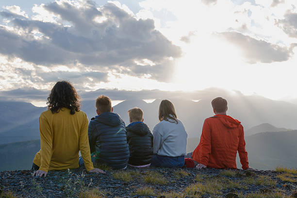 istock Family explores mountain ridge crest at sunset 2234511168