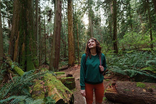 Woman exploring serene forest in Vancouver, Canada in summer