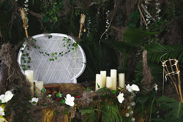 Decorative Jungle-Themed Setting with Chair, Tropical Plants, and Candles
