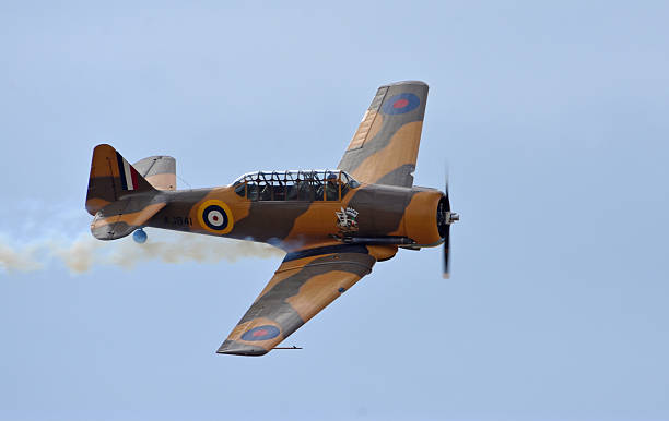 Little Gransden, Cambridgeshire, England - August 24, 2025: Vintage North American T-6 Harvard aircraft in flight