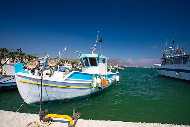 Boats docked in a harbor on a sunny day with clear blue sky on the Greek island of Kos