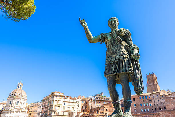 Emperor Trajan Statue in Rome Italy monument. Ancient Italian leadership. Blue sky in summer copy space.