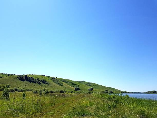 istock Green hills and blue sky with clouds 2234514863