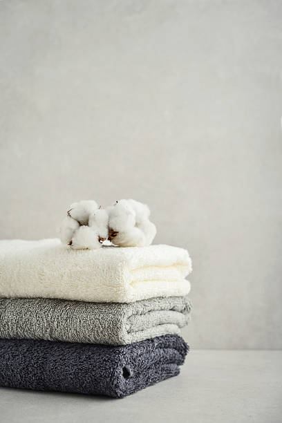 istock Stack of bath towels with cotton flowers 2234515243