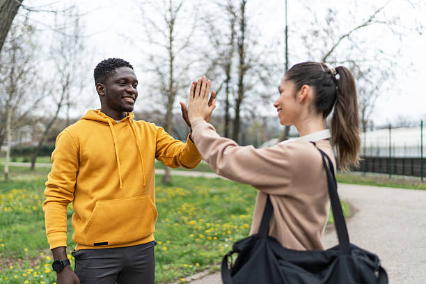 istock Young athletes giving high five after training in park 2234515545