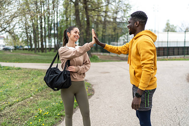 istock Two young adults giving high five after training outdoors 2234515549