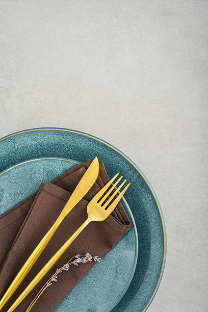 istock table place setting with blue plates and golden cutlery 2234515597