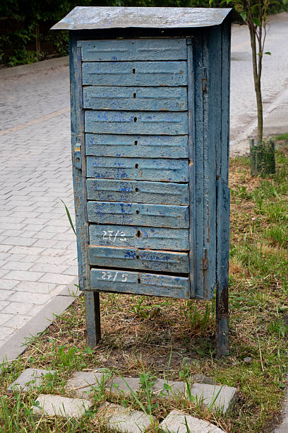 istock Old and Rusted Communal Mailboxes with Peeling Blue Paint on a City Street 2234516569