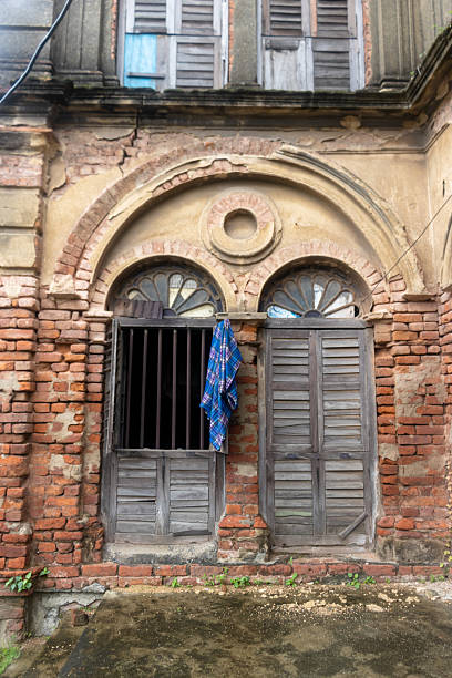 istock Old Colonial Building Facade with Arched Windows and Wooden Shutters 2234517380