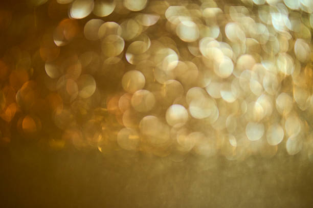 High-resolution abstract background featuring large, defocused golden bokeh circles that fade into a soft gradient from warm yellow–gold at the center to deeper olive tones toward the edges. The luminous, shimmering texture suggests celebration, luxury, and warmth, while the broad out-of-focus area provides generous copy space for headlines or logos. Ideal for website hero images, banners, posters, invitations, packaging mockups, holiday and event graphics, beauty/wellness branding, and other design applications. Horizontal orientation; full frame, no people, no visible trademarks—suitable for editorial and conceptual commercial use per agency guidelines.