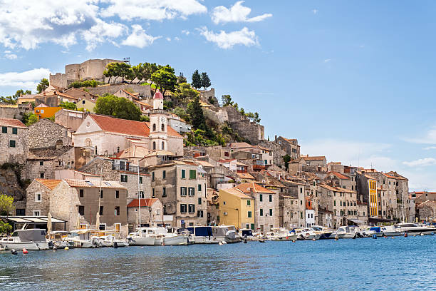 istock Beautiful old town waterfront with traditional stone architecture, terracotta roofs, medieval castle and fishing boats in scenic Croatian port 2234520917