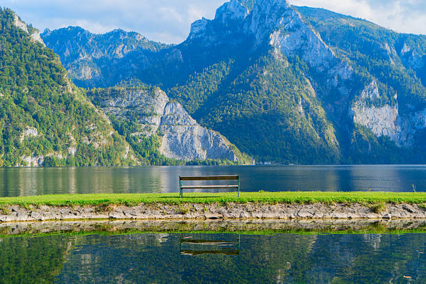 A picturesque Hallstatt lakeside between the stunning mountains and gentle misty clouds above, Austria