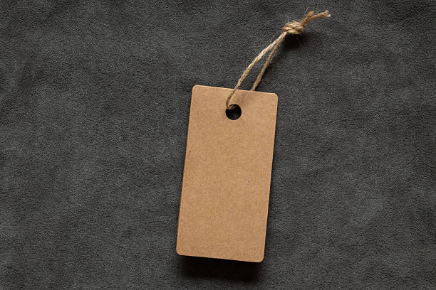 istock A brown blank tag on a rope lies on a gray fleecy fabric as a mockup for a design 2234527632