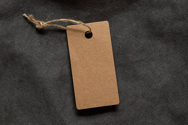 istock A brown blank tag on a rope lies on a gray fleecy fabric as a mockup for a design 2234528529