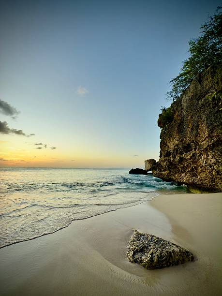 istock Tranquil beach at sunset with rocky cliff 2234532781