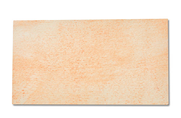 close up of a ripped colored vintage note paper on white background