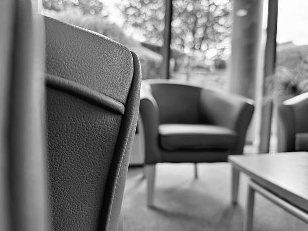 Comfortable corduroy armchair and sofa in a bright, minimalist living room