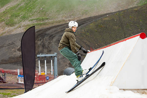 istock Boy practicing ski jibbing in summer snow park 2234538215