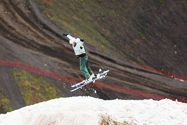 Boy practicing ski jumping in summer snow park