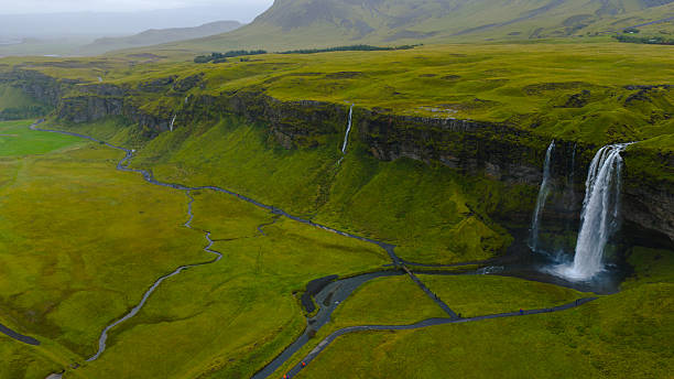 istock Seljalandsfoss Waterfall with Lush Green Fields and Walking Paths 2234539903