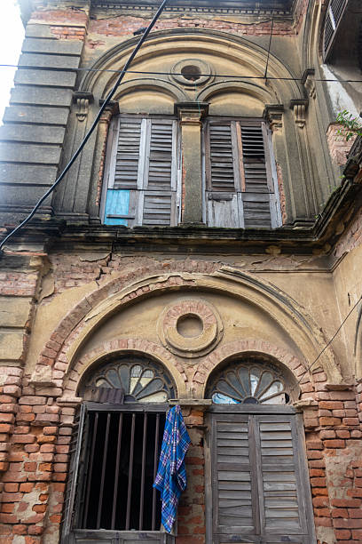 istock Old Colonial Building Facade with Arched Windows and Wooden Shutters 2234540686