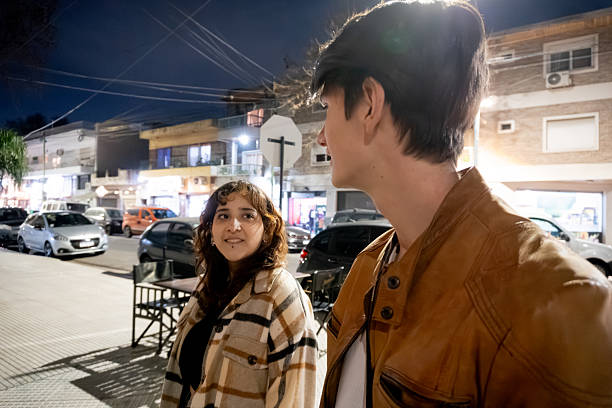 istock Young couple talking while walking in the city 2234541324