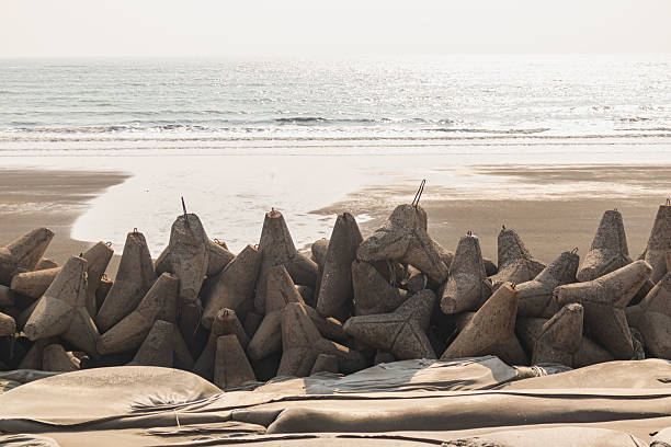 istock Strong concrete Teknaf wave breakers standing firm against ocean tides on sunny coastal afternoon. 2234542846