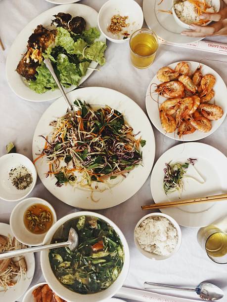 Vietnamese family-style meal with shrimp, salad, and rice