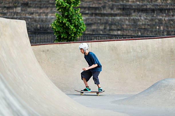 istock Boy Skateboarding in Urban Skate Park bowl 2234547703