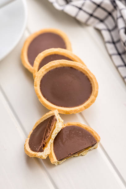 istock Sweet chocolate tartelettes on white table. 2234549431