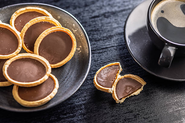 istock Sweet chocolate tartelettes on plate on black table. 2234549674