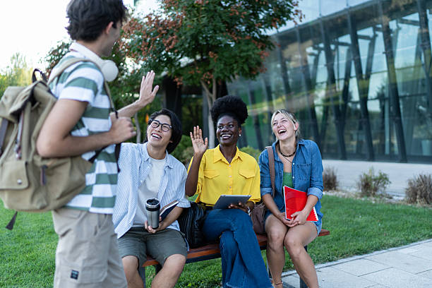 istock Happy diverse students greeting each other on campus 2234549800