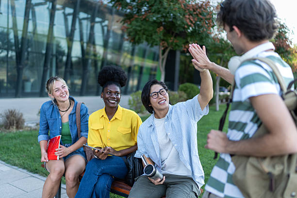 istock Happy students giving high five outdoors after university exam 2234549889
