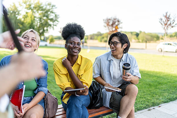 istock Multi-ethnic students listening to teacher outdoors on campus 2234550011