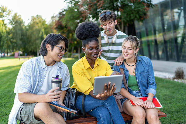 istock University students collaborating on a project using a digital tablet outdoors 2234550041
