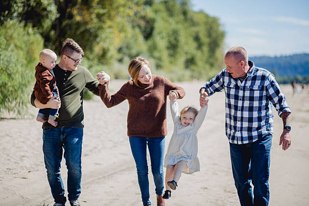 istock Multi Generational Family Walking Together on the Riverfront Beach in the Pacific Northwest 2234551049