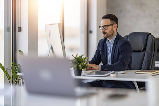 istock Professional man working at desk in modern office during daylight hours focusing on computer tasks 2234551213