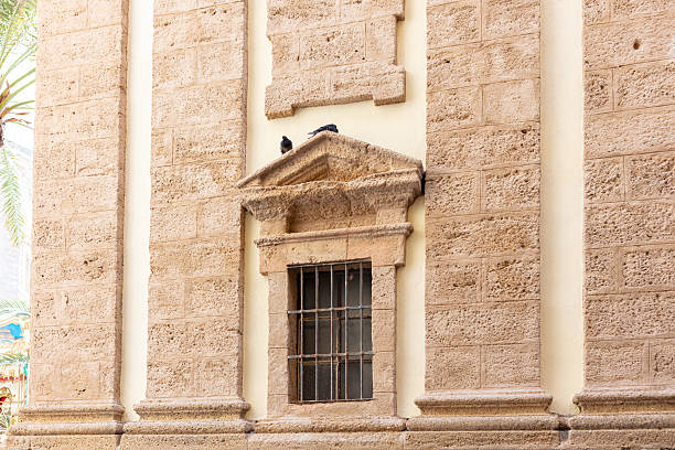 Close-up of textured sandstone wall with rough surface pattern. Cadiz, Andalusia, Spain, September 2025. High quality photo