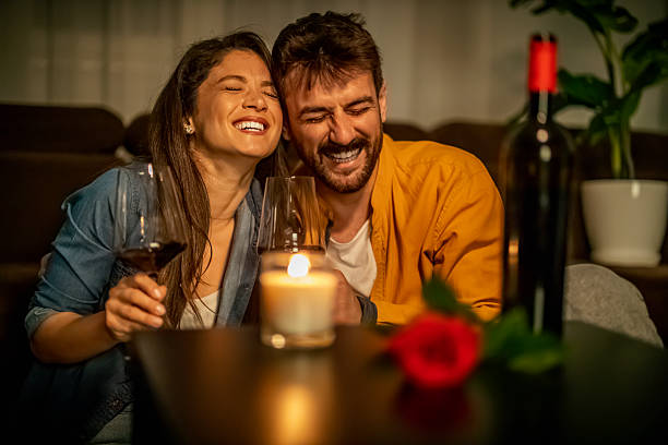 istock Couple enjoys romantic evening with wine and laughter at home 2234553424