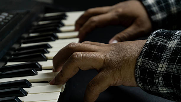 istock Pianist hands playing with both hands viewed from diagonal top angle, black piano with dark background, concept of concert, melody, art, and expressive performance. 2234553570
