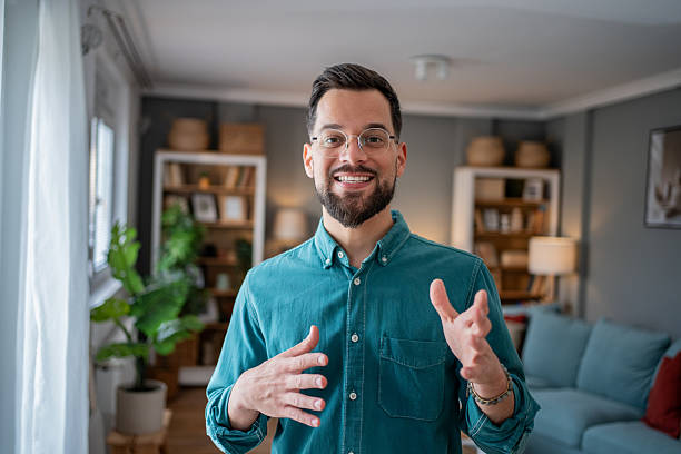 istock Young businessman having video call from home office, gesturing and smiling 2234556358