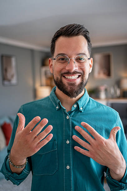istock Smiling young man gesturing with hands during video call 2234556466